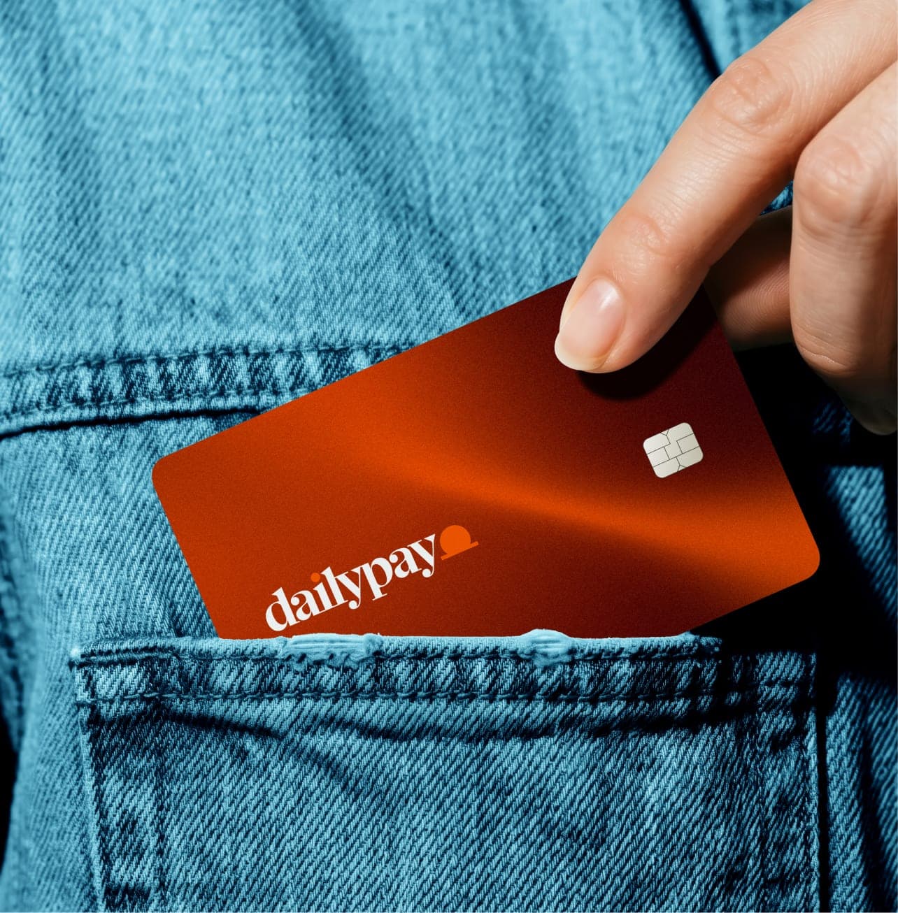 DailyPay orange debit card in pocket