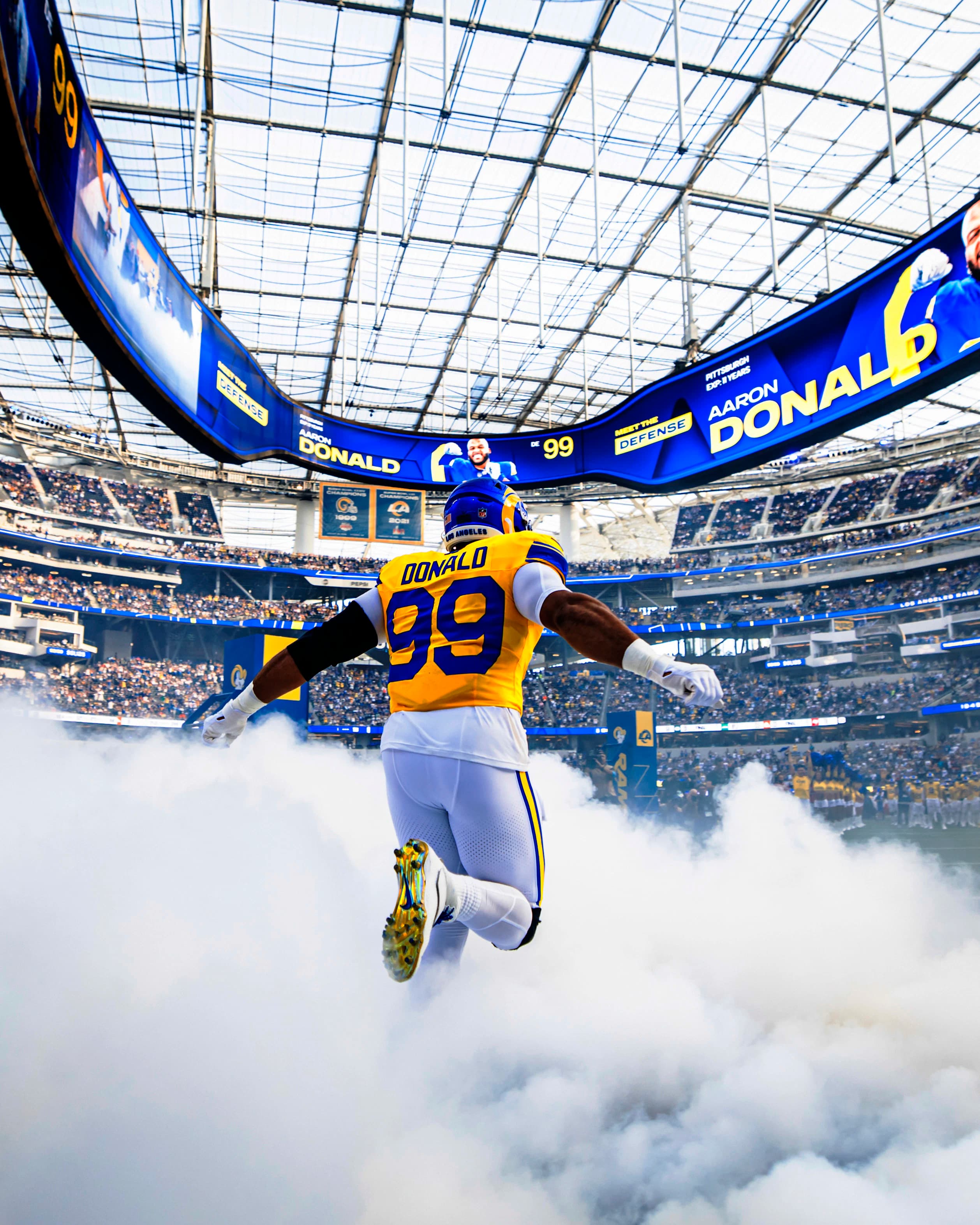 Aaron Donald leaping out of the tunnel smoke at SoFi Stadium