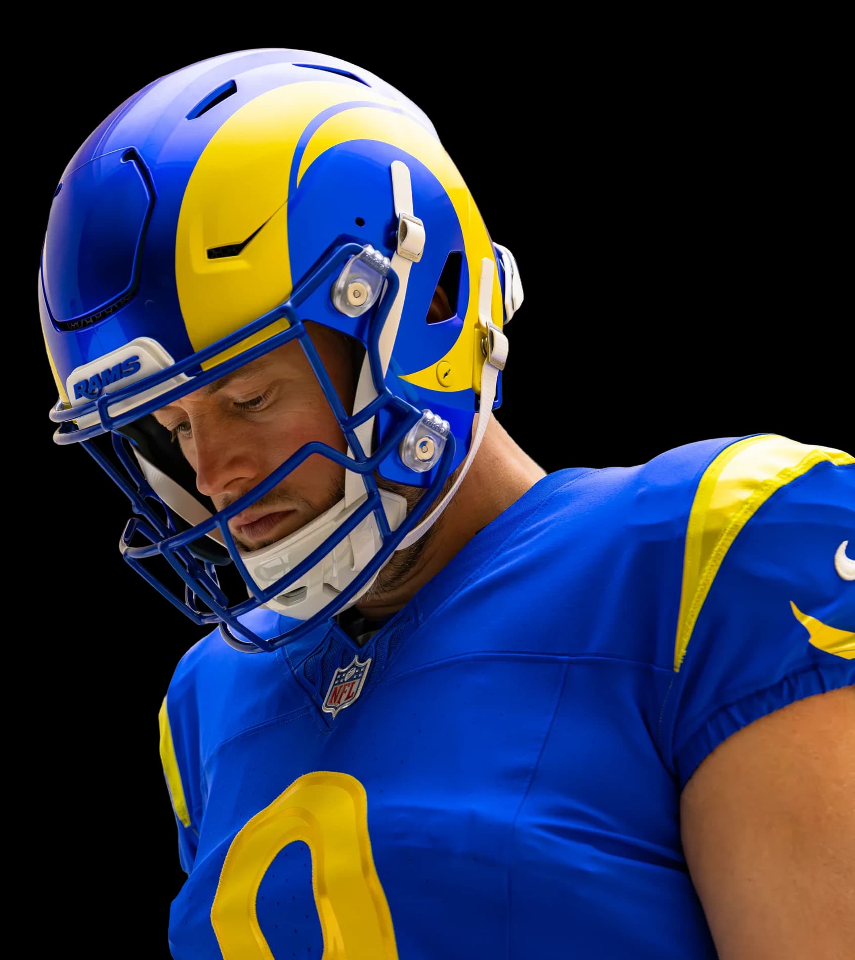 Matthew Stafford in the royal and sol helmet, head bowed