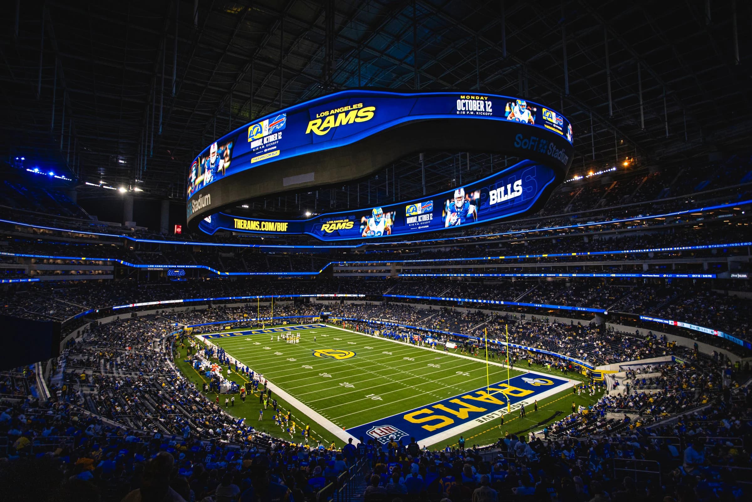 SoFi Stadium bowl under the Infinity Screen at night