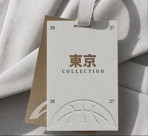 Tokyo Collection swing tag with a blind-embossed Project B arc mark