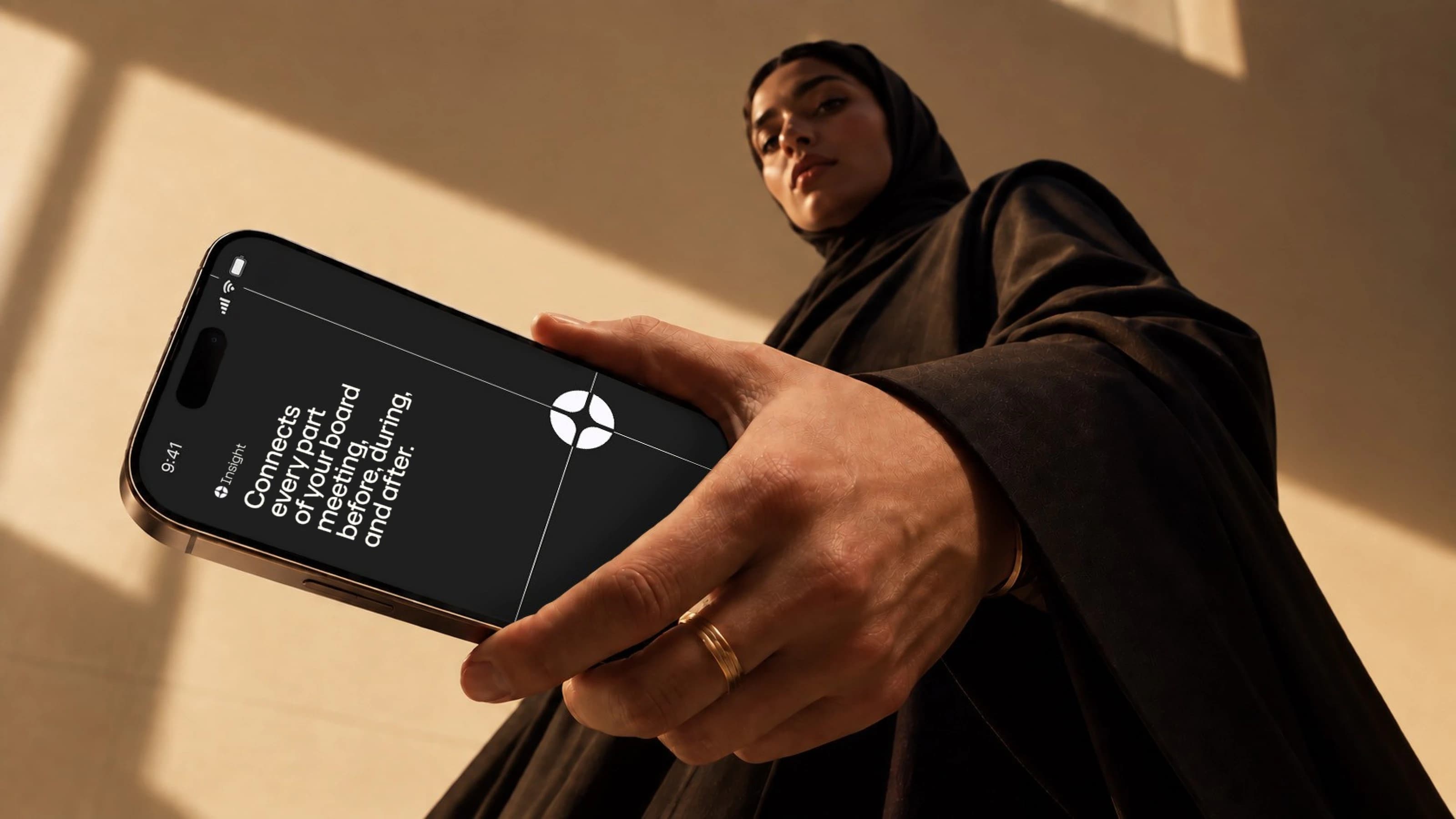A phone showing the Insight app: connects every part of your board meeting, before, during, and after.